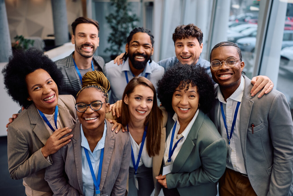 A diverse sales team standing together in a modern workplace.